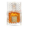 A bottle of Khamrah by Lattafa perfume, featuring a clear glass bottle with a textured geometric pattern and filled with amber-colored liquid. The bottle has a matching clear cap and a gold label with Arabic and English text.